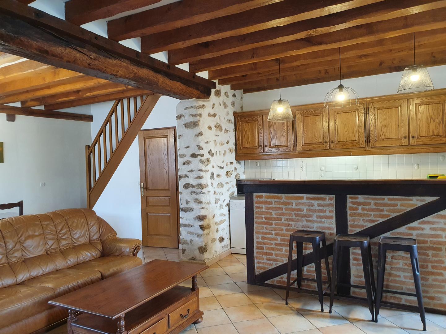 Gîte AUTOMNE, Grande salle, côté cuisine ouverte, plaque cuisson, micro-ondes, lave-vaisselle.