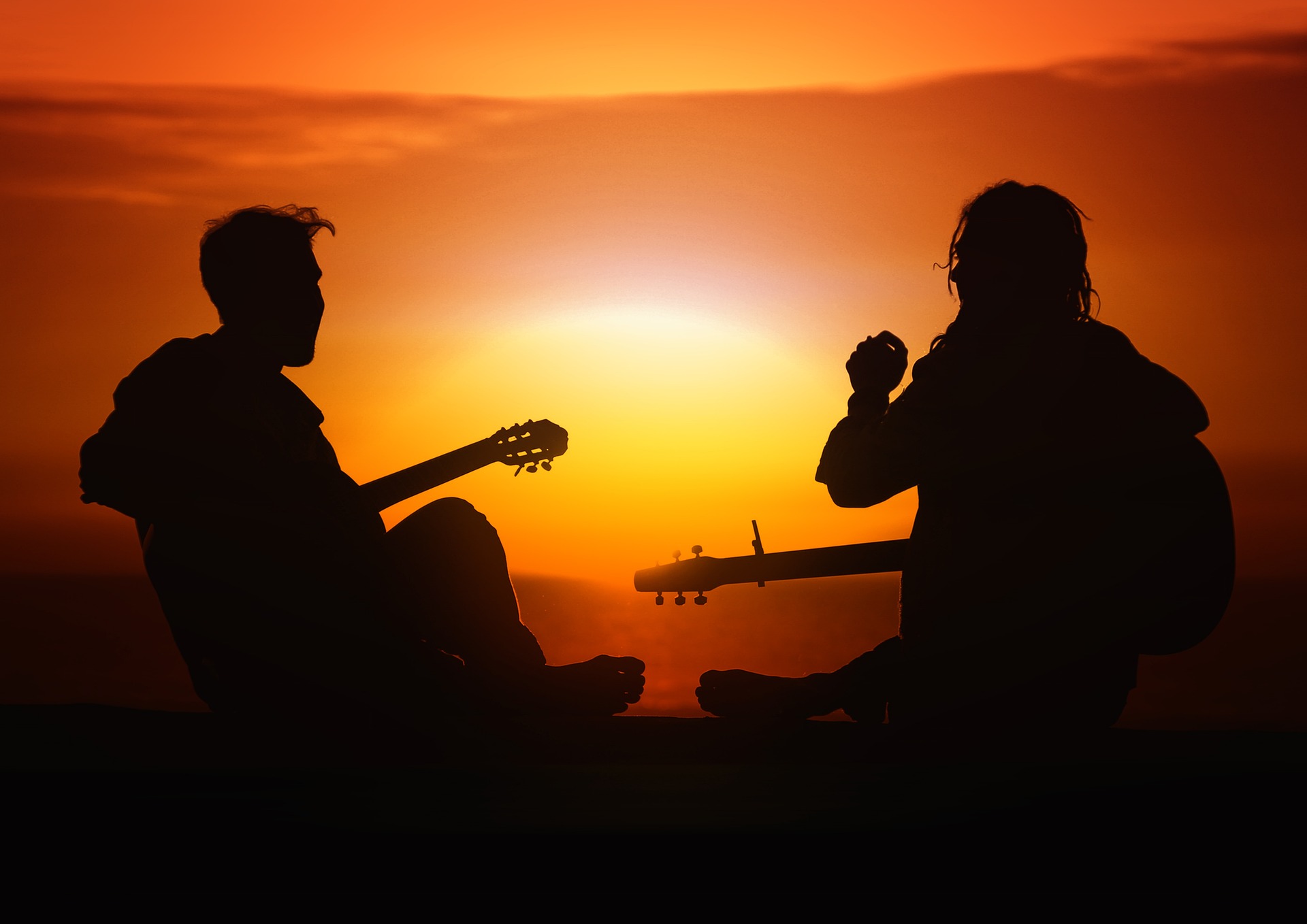 Two guitarists at sunset