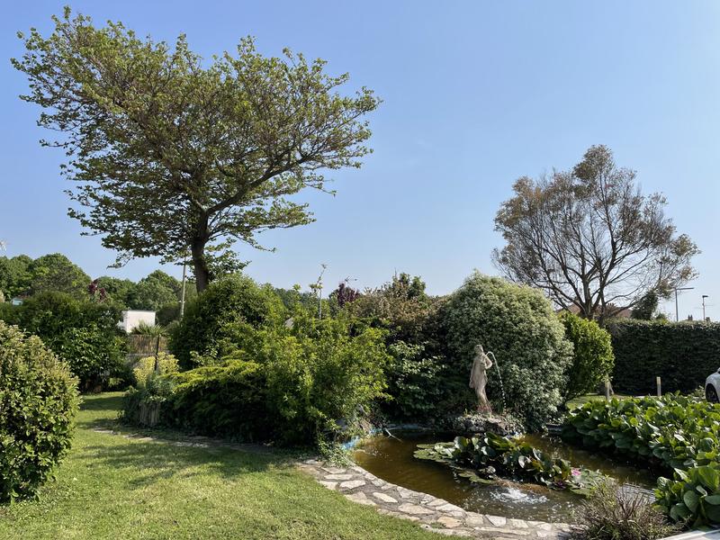 Le jardin arboré, avec une marre et une fontaine.