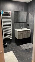 Salle bains modèrne avec meuble vasque, grand miroir et sèche serviettes
