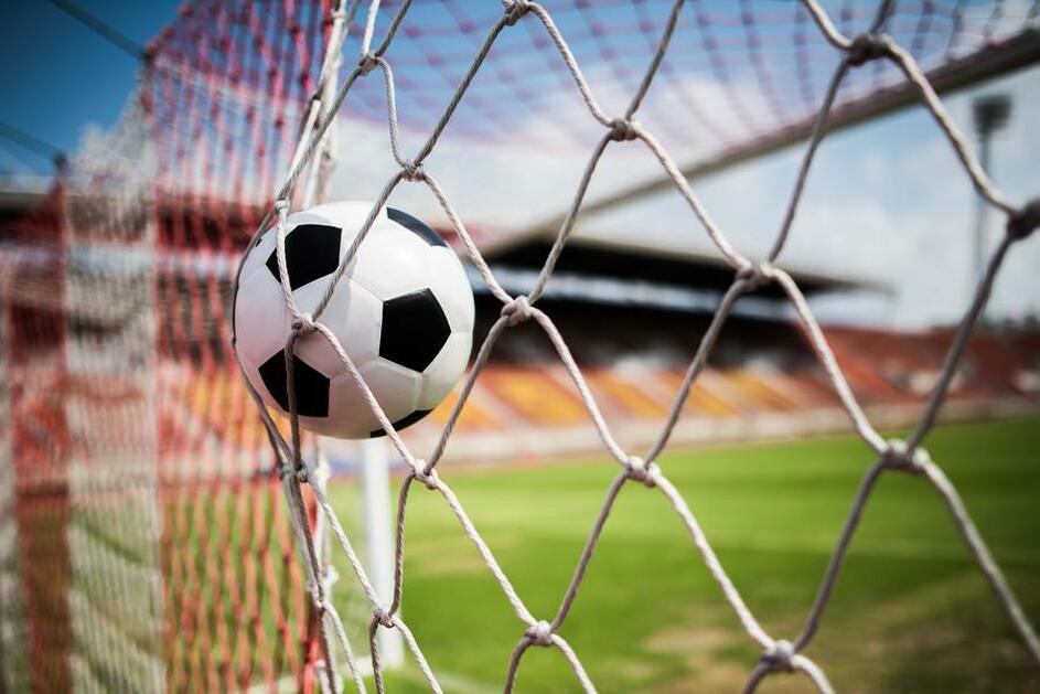 A soccer ball goes into a cage