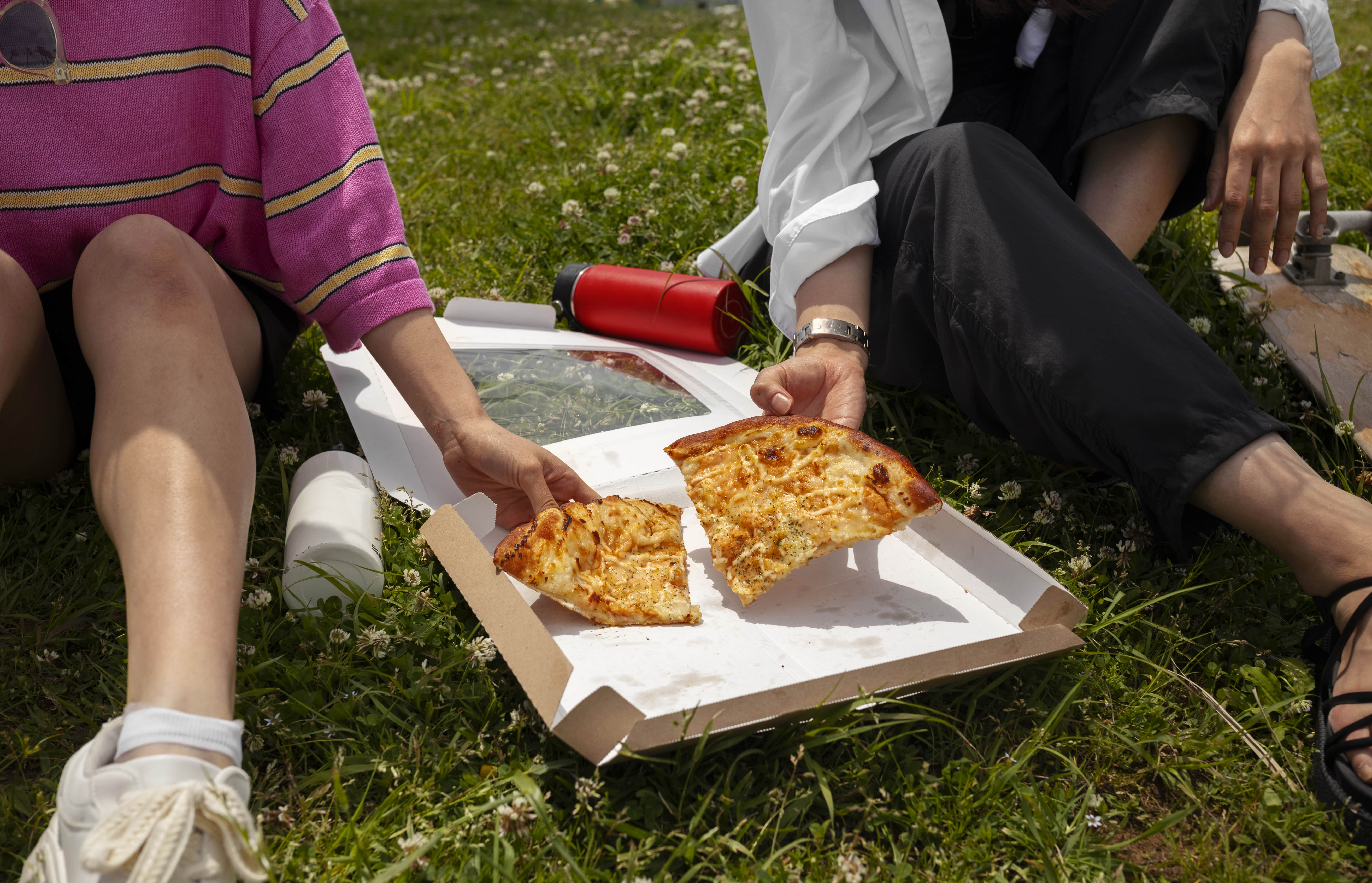 people-enjoying-pizza-snack-outdoors-min