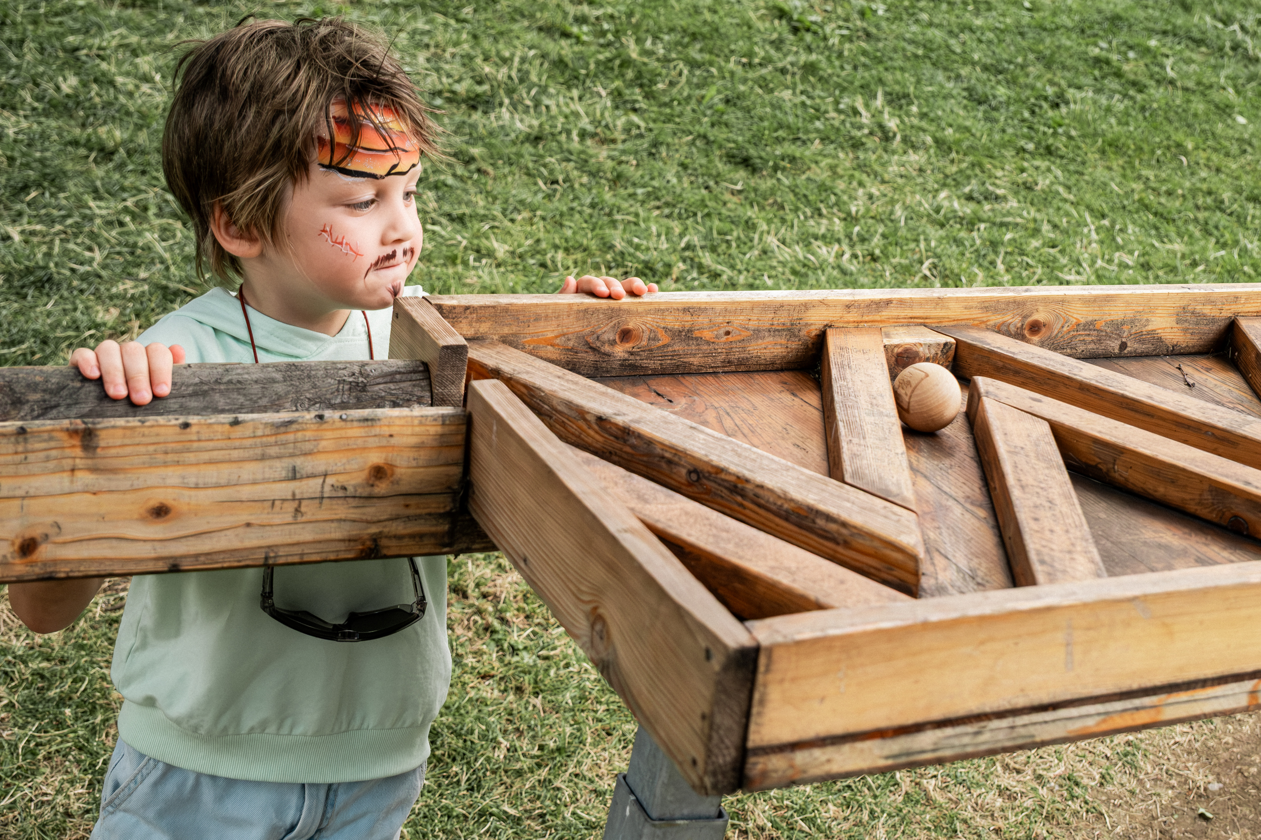 Boy following the ball on the course