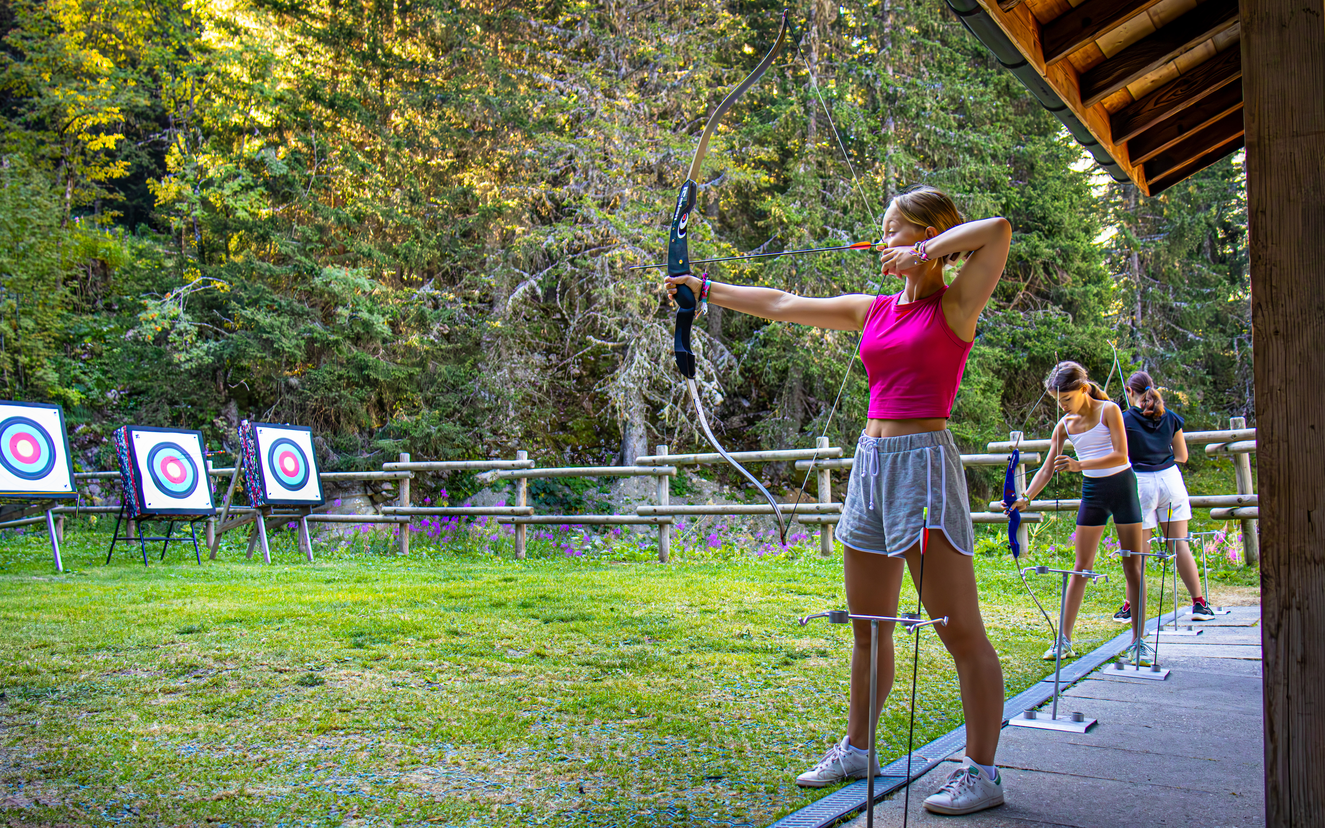 Wide shot of a group of girls facing the targets