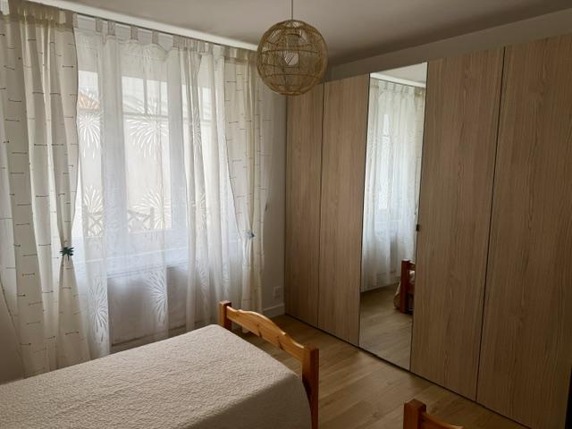 Une chambre avec deux lits, une penderie.