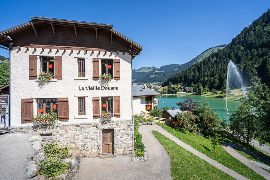 La Vieille Douane en été au bord du Lac de Vonnes et son Jet d'eau et sur la route de Vonnes en direction de la frontière suisse et de Morgins