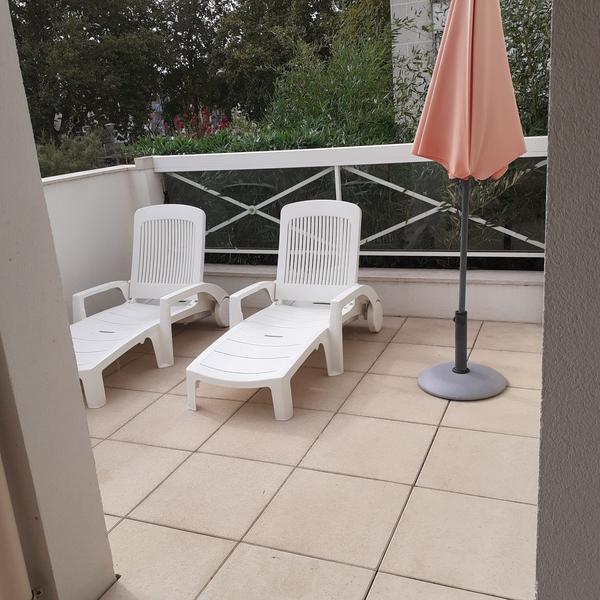 2 transats et parasol sur terrasse