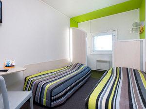 Une chambre avec deux lits simples.
