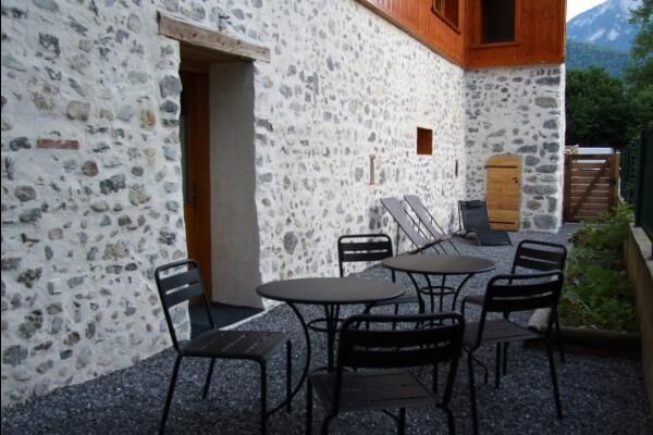 Jardin privatif avec salon de jardin, parasol et barbecue