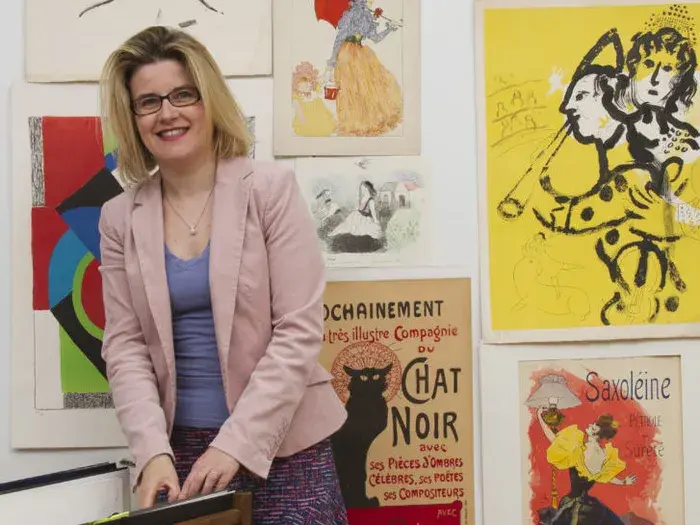 Femme devant des affiches et estampes 