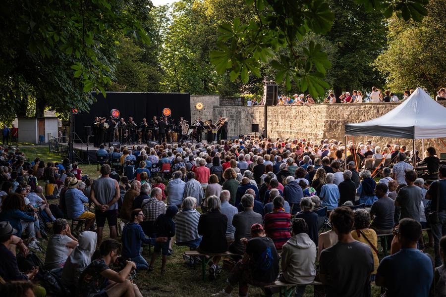 Scène des douves avec du public et des artistes sur scène