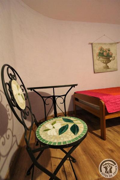 Grand gîte \'La Mamounière\' à St-Jean-la-Bussière - maison de vacances 4 chambres (Rhône, Beaujolais vert, Près du Lac des sapins) : table et chaise dans la Chambre \'Fruits de la passion\'.