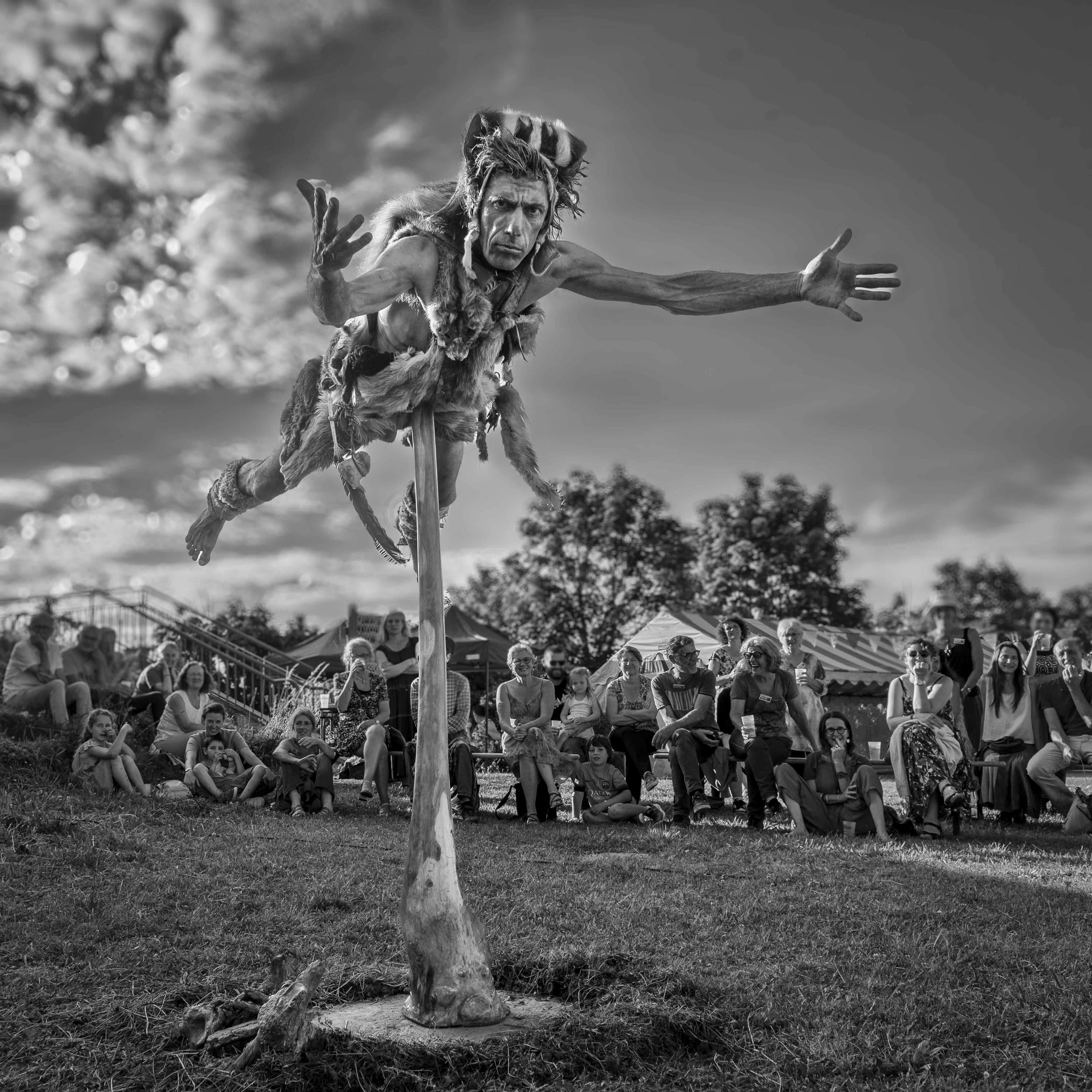 An actor dressed as a prehistoric man