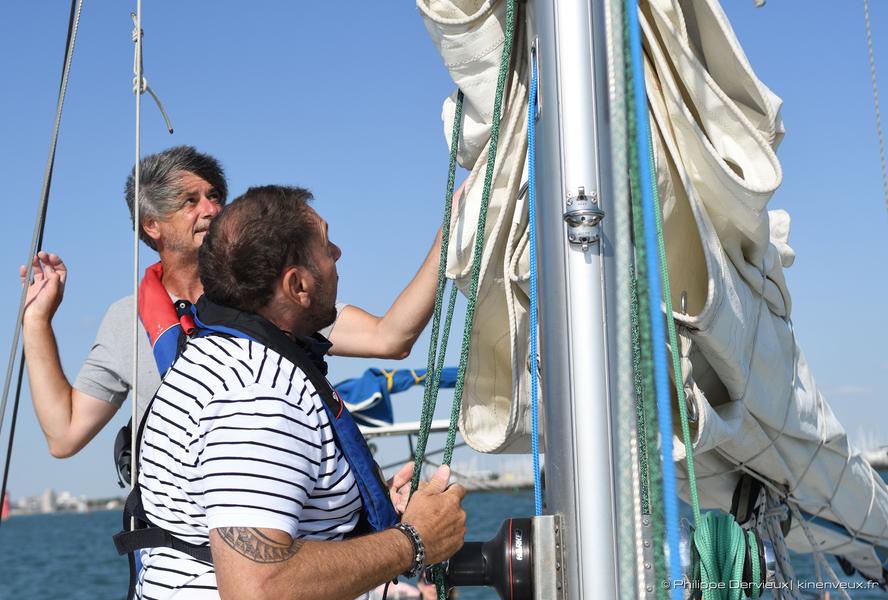 Participant hissant la grande voile