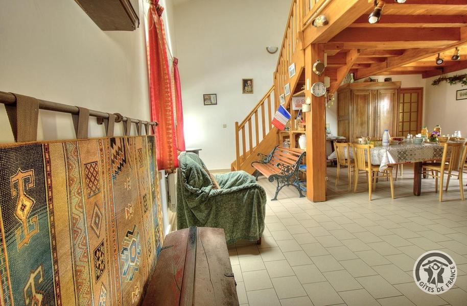 Gîte de la Collonge à Affoux, en Haut Beaujolais, dans le Rhône : escaliers dans le séjour conduisant à la mezzanine et chambres à l\'étage.