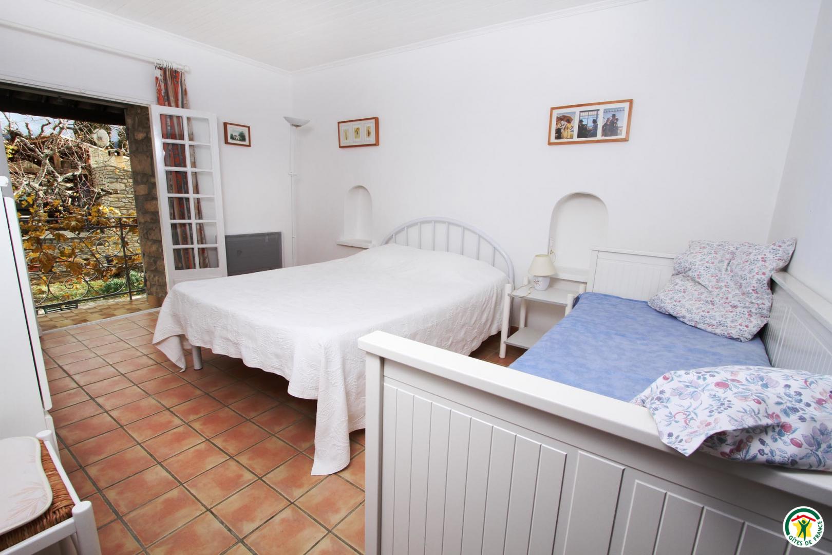 A l'étage grande chambre ouvrant par un balcon sur le jardin