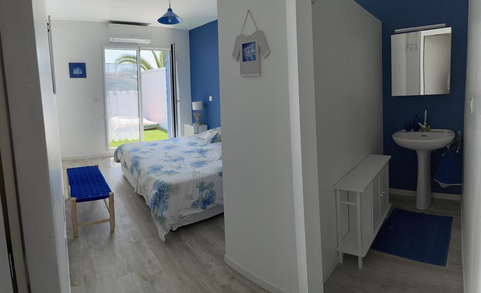 Une chambre avec un lit double, salle d'eau.