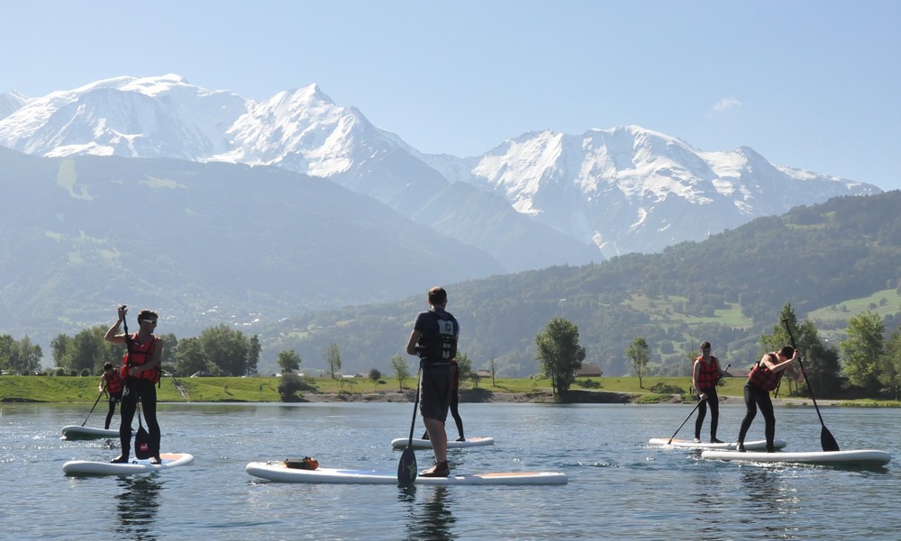 Personnes pratiquant du stand up paddle face au Mont Blanc