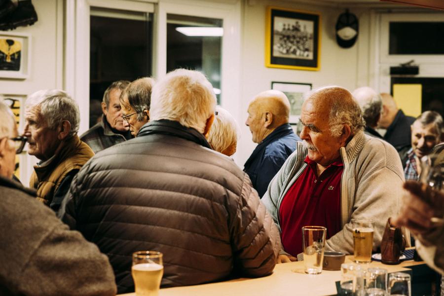 Des clients accoudés au bar.