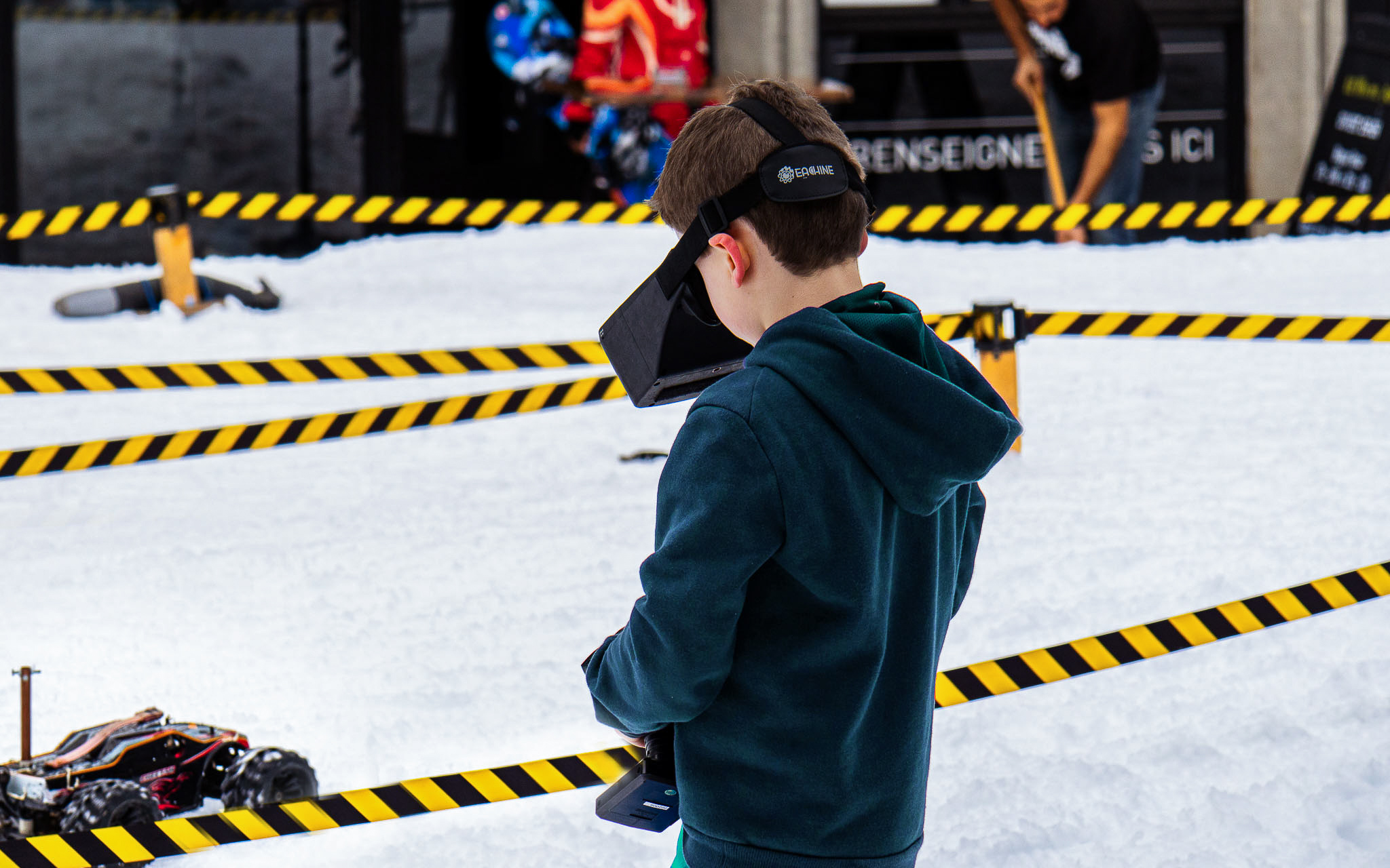 Child with virtual reality helmet driving the buggy in front of him