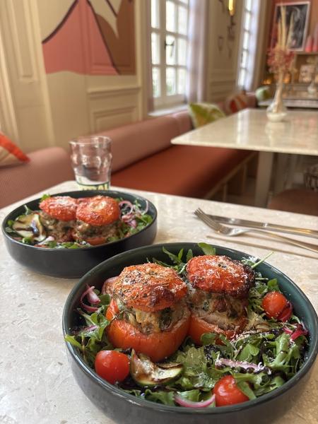 Deux assiettes de tomates farcies et salades.